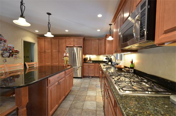 47 Pierpont Road Dudley, MA 01571 - Photo 10 of 30 a kitchen with stainless steel appliances granite countertop a sink stove and refrigerator