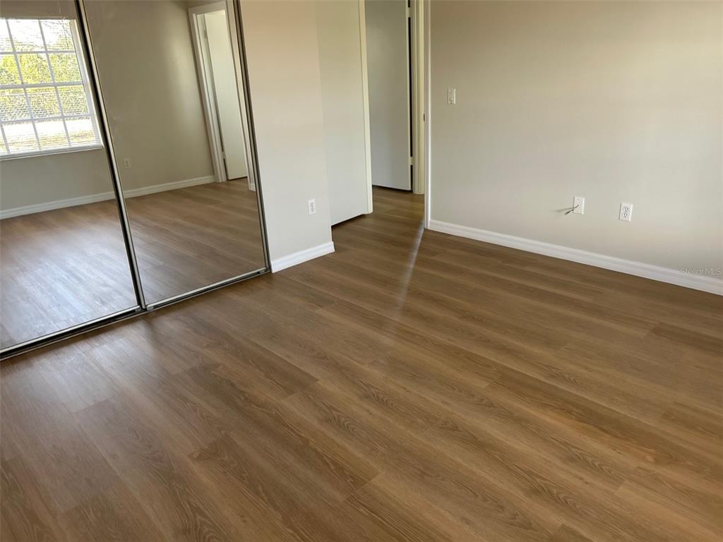 301 Oak Track Loop Ocala, FL 34472 - Photo 11 of 14 an empty room with wooden floor and a window
