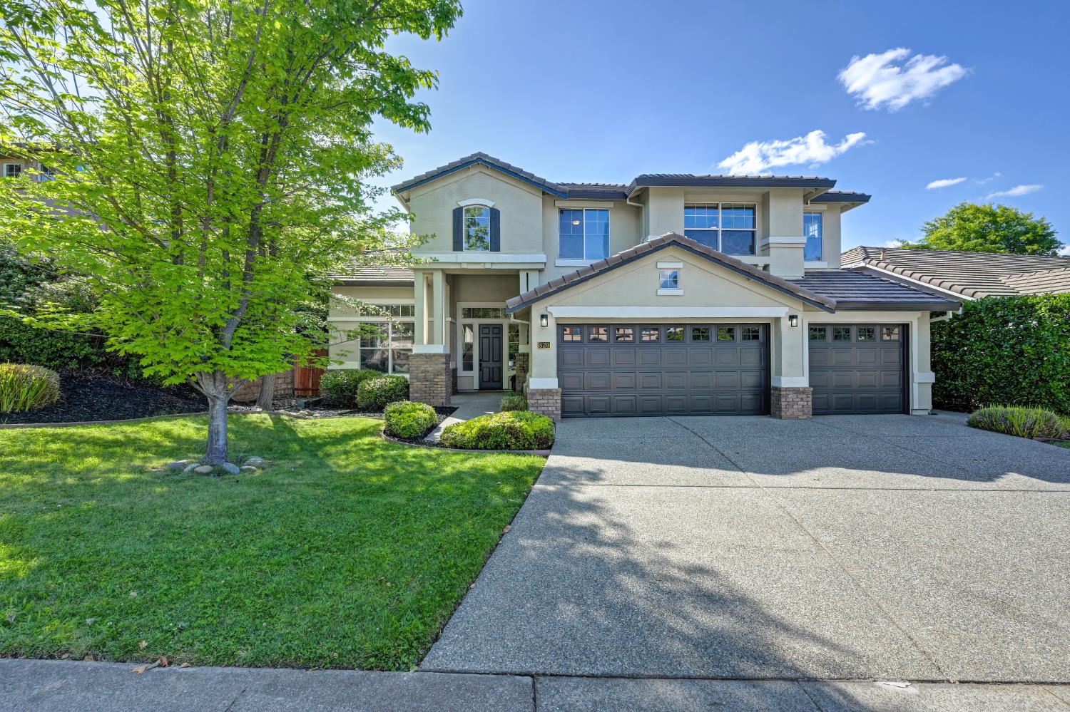 a front view of a house with a yard and garage