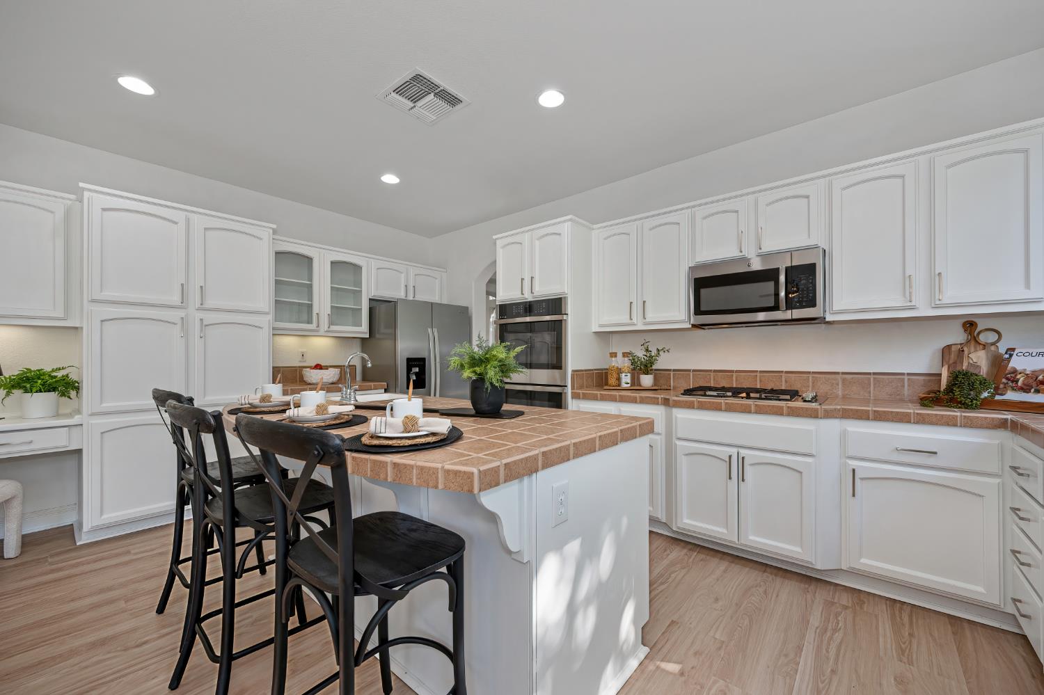 820 Travis Street Folsom, CA 95630 - Photo 13 of 47 a kitchen with stainless steel appliances granite countertop a table chairs sink and cabinets