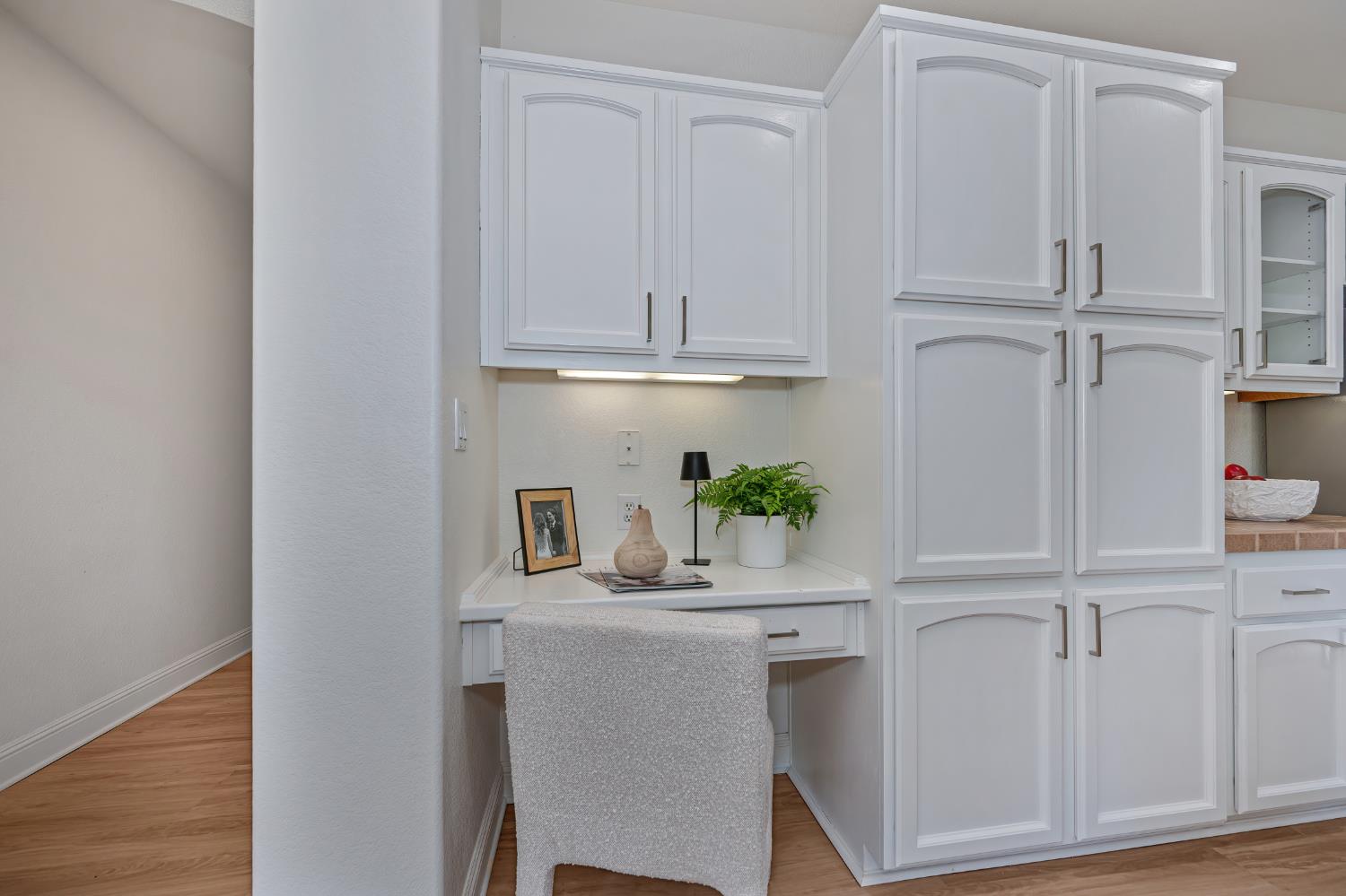 820 Travis Street Folsom, CA 95630 - Photo 15 of 47 a kitchen with white cabinets and wooden floor
