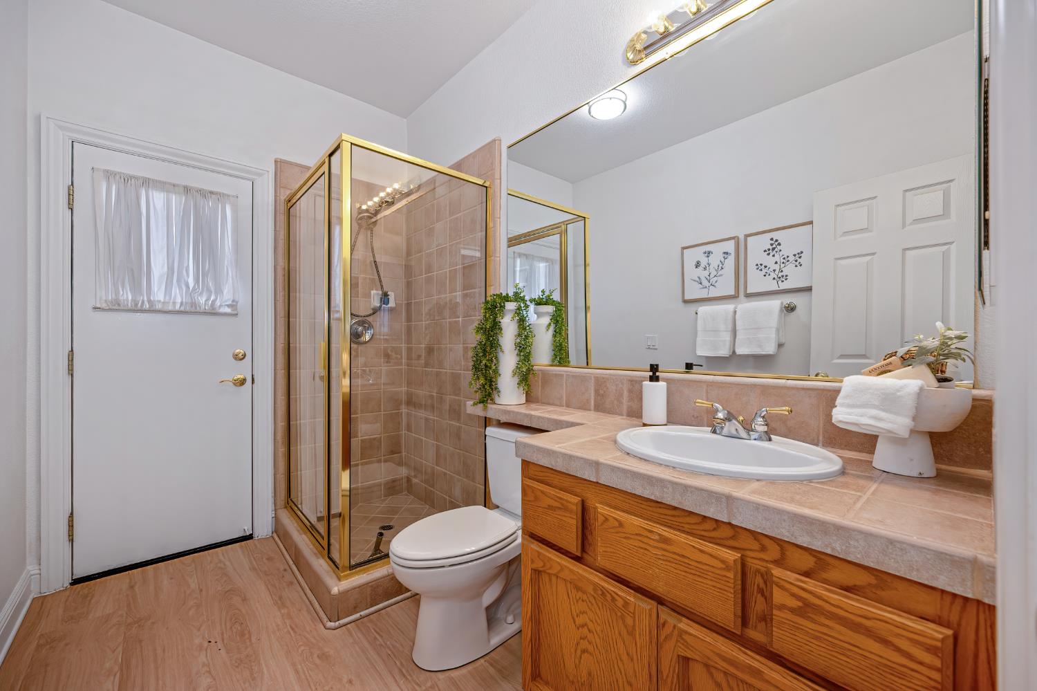 820 Travis Street Folsom, CA 95630 - Photo 25 of 47 a bathroom with a granite countertop sink a toilet and shower