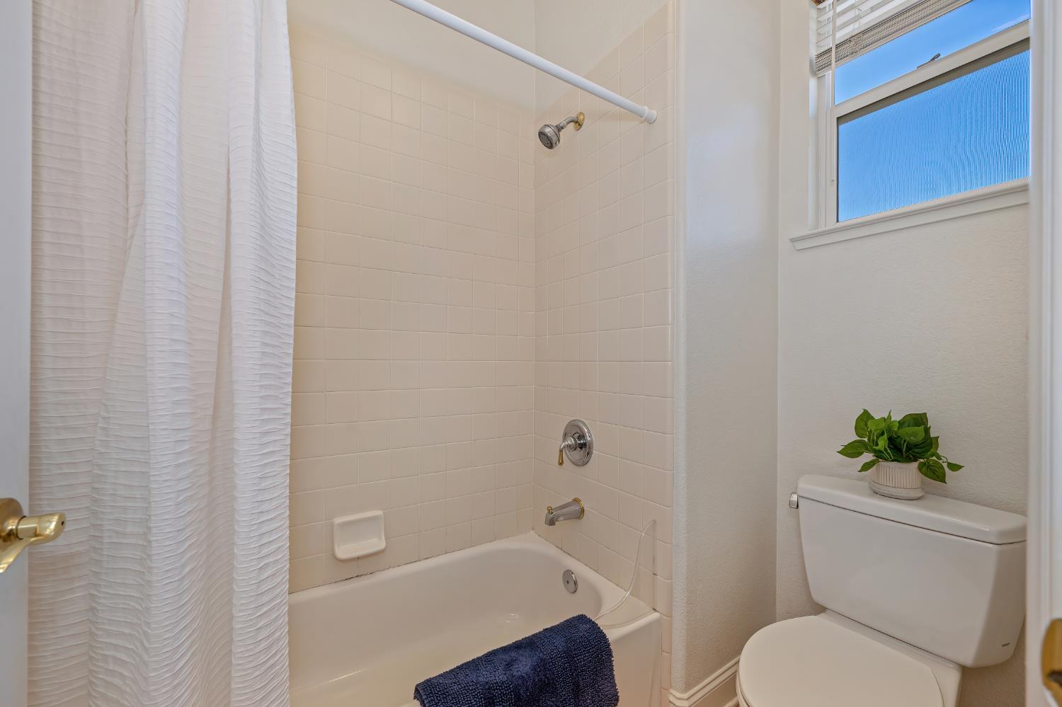 820 Travis Street Folsom, CA 95630 - Photo 38 of 47 a bathroom with a toilet and a shower curtain