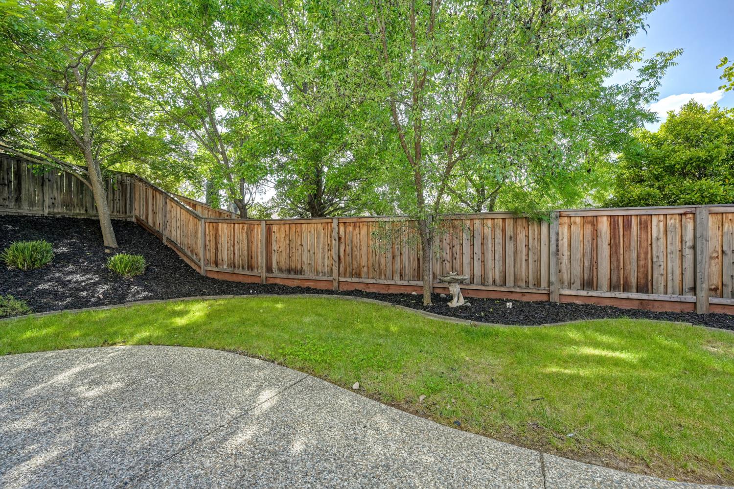820 Travis Street Folsom, CA 95630 - Photo 43 of 47 a view of a backyard with a garden and wooden fence