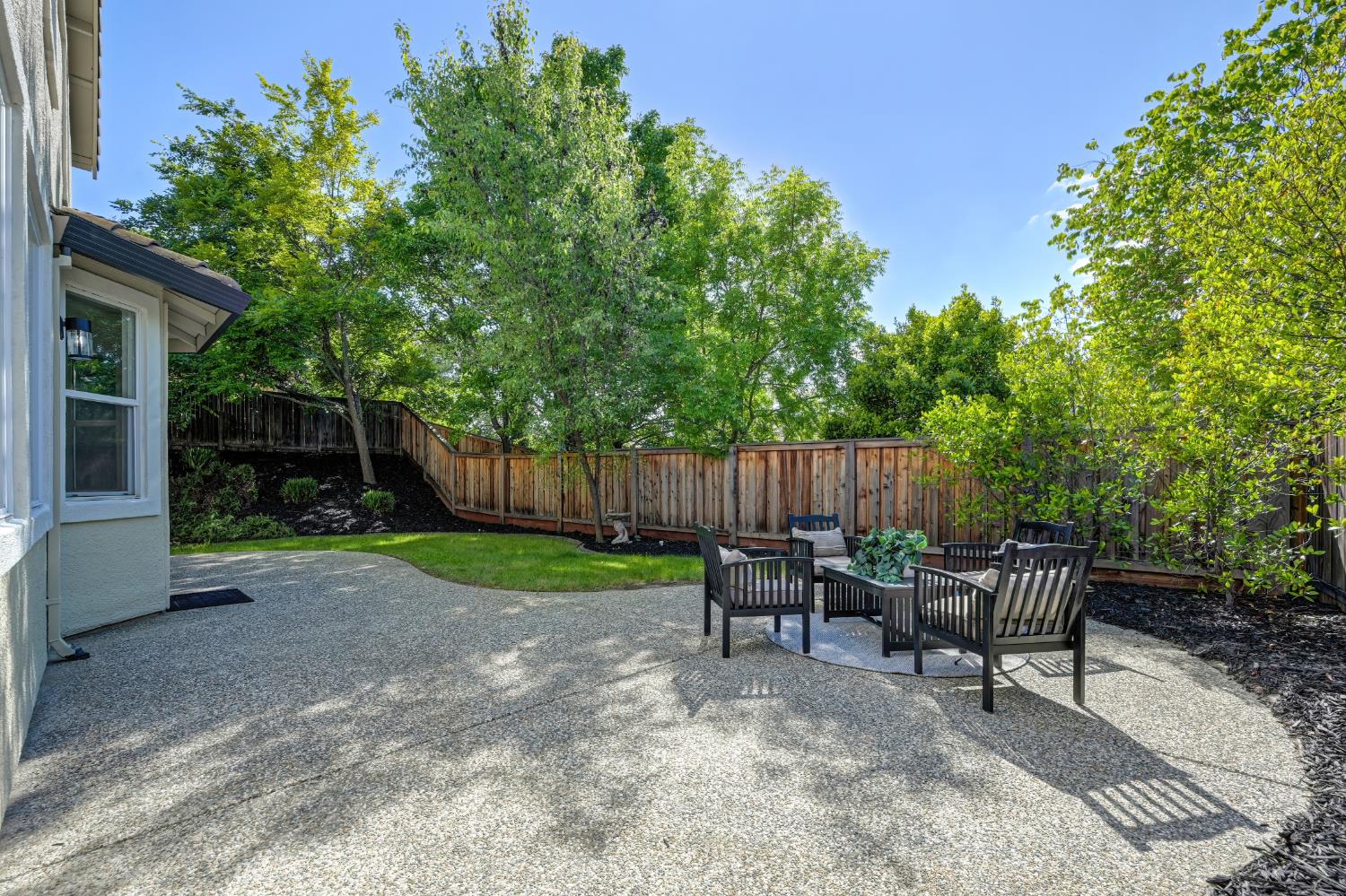 820 Travis Street Folsom, CA 95630 - Photo 44 of 47 a view of backyard with wooden fence and a large tree