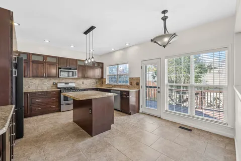 a kitchen with granite countertop a sink and a window