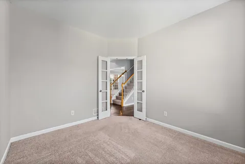 a spacious bathroom with a double vanity sink mirror and chandelier