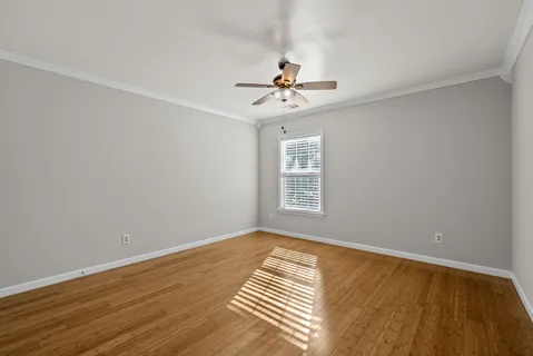 a view of an empty room with wooden floor