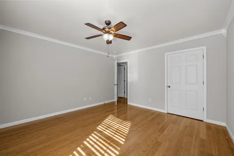 a view of a hallway with windows and chandelier