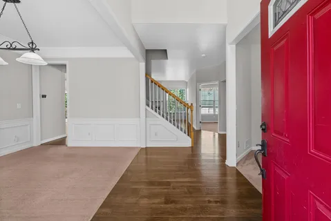 a view of entryway and hall with wooden floor