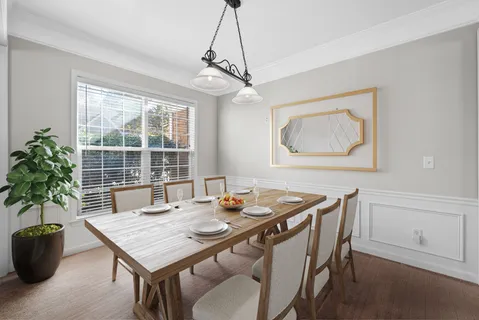 a dining room with a table and chairs