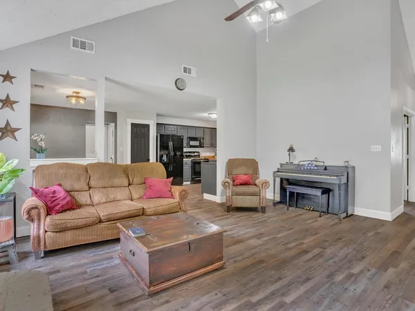 a living room with furniture a fireplace and a chandelier