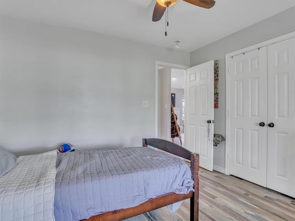 15067 Meadow Ridge Court Nevada, TX 75173 - Photo 15 of 39 a bedroom with a bed and cabinets