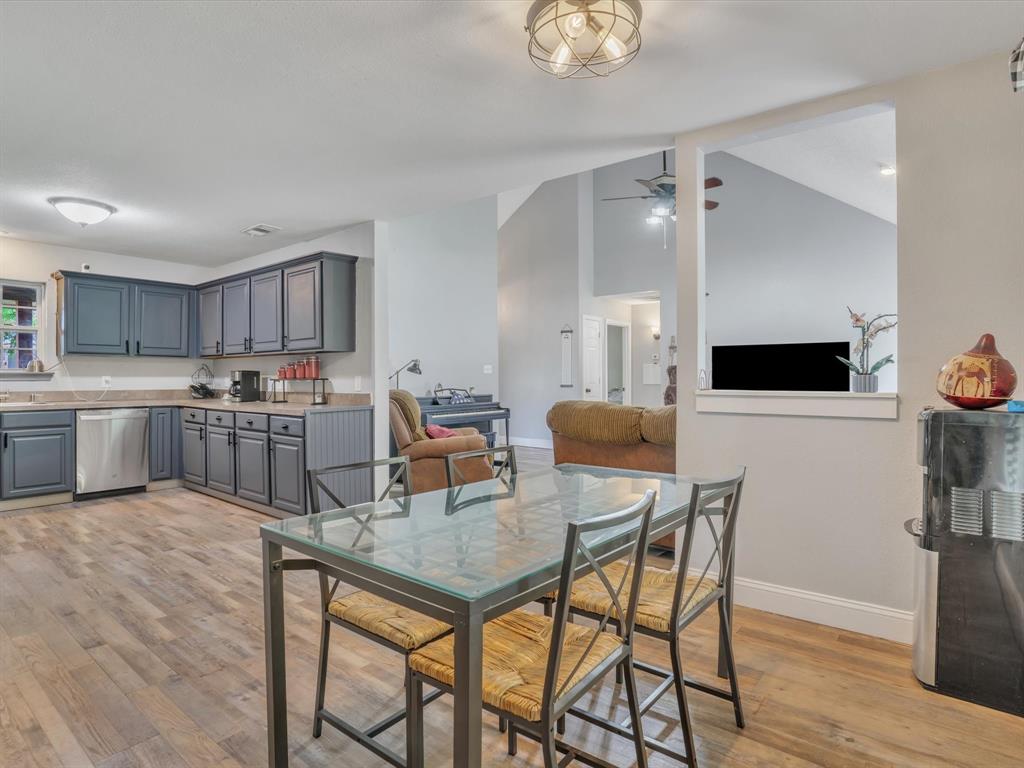 15067 Meadow Ridge Court Nevada, TX 75173 - Photo 20 of 39 a kitchen with a table chairs refrigerator and wooden cabinets