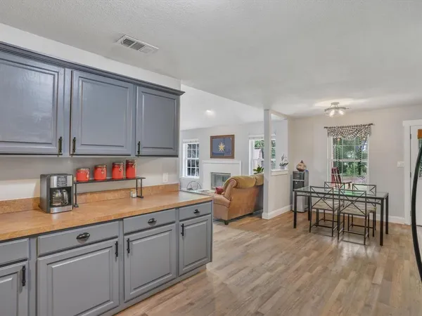 a kitchen with white cabinets and sink