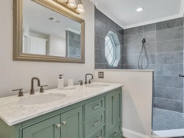 a bathroom with a double vanity sink and a mirror