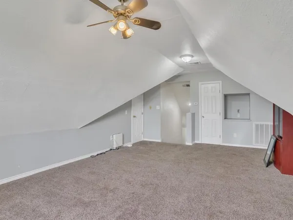 a view of a livingroom with a ceiling fan and window
