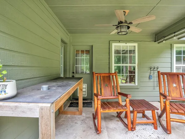 a view of backyard with a table and chairs