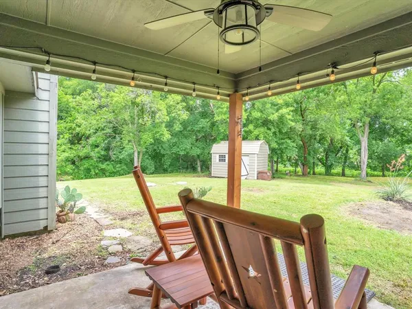 a view of a porch with furniture and garden