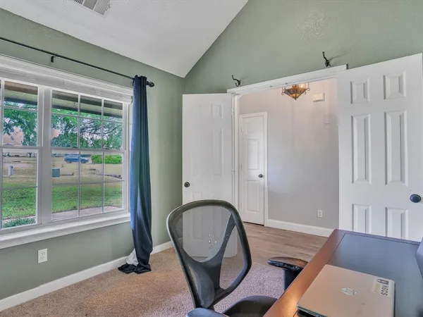 a dining room with furniture and a window