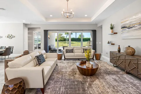 a view of a dining room with furniture and large windows