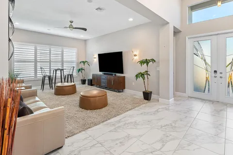 an aerial view of a house with a garden and lake view