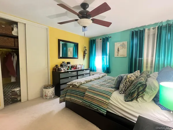 a bedroom with a bed dresser and a window