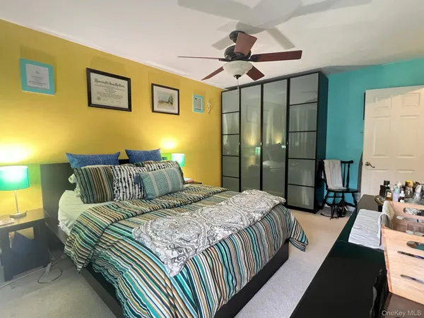 a bedroom with bed and a chandelier