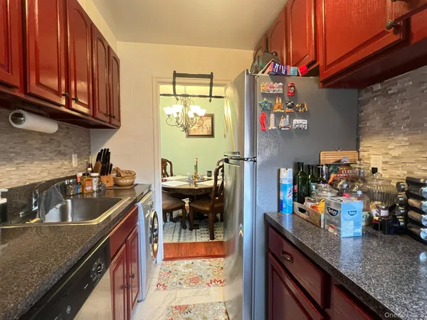 a kitchen with stainless steel appliances granite countertop a sink stove and cabinets