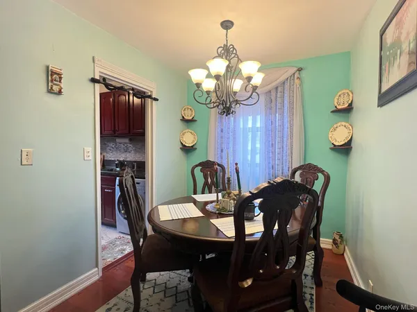 a view of a dining room with furniture and chandelier