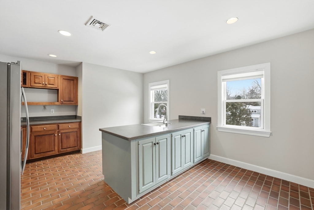 74 Branch Street, Unit 15 Scituate, MA 02066 - Photo 12 of 26 a kitchen with granite countertop a sink stove and cabinets