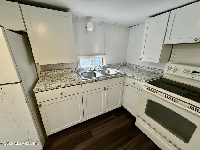 a kitchen with a sink stove and cabinets
