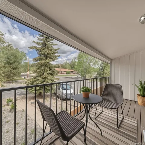 a view of a chairs and table in the balcony
