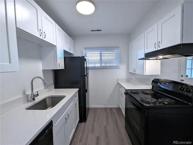 a kitchen that has a sink and a stove