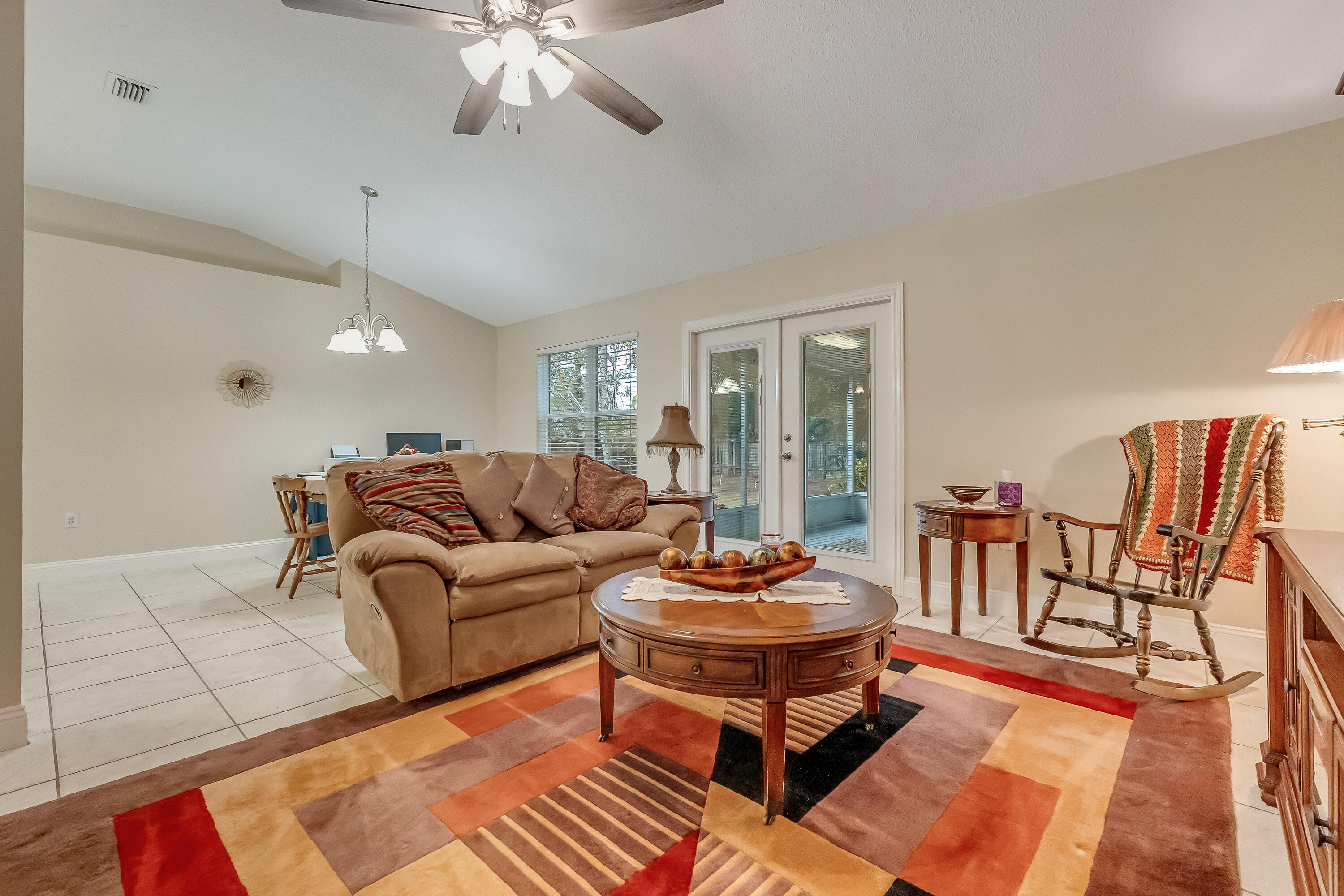 4730 Connor Drive Crestview, FL 32539 - Photo 11 of 71 a living room with furniture a rug and a chandelier