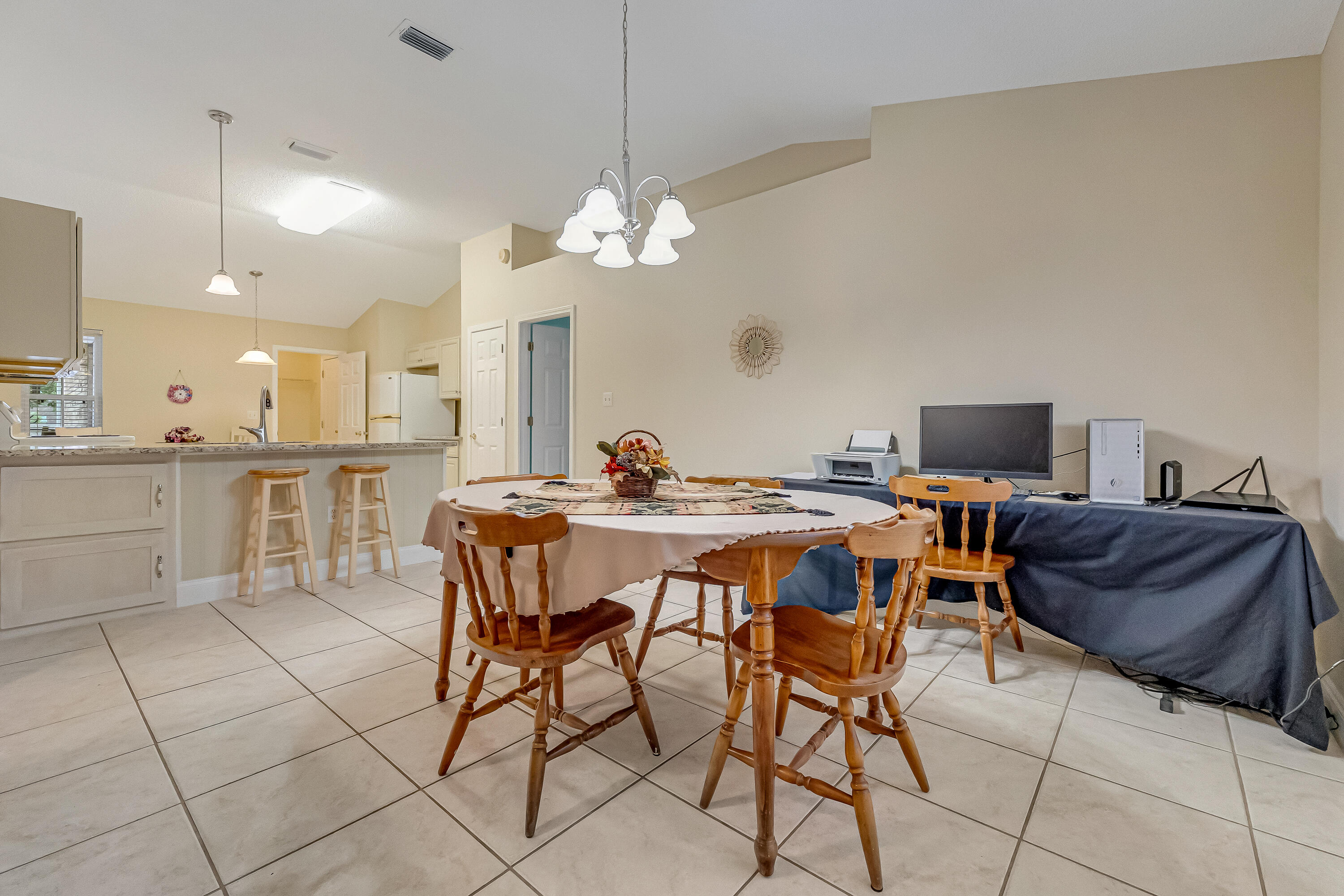 4730 Connor Drive Crestview, FL 32539 - Photo 15 of 71 a view of a dining room with furniture and a chandelier