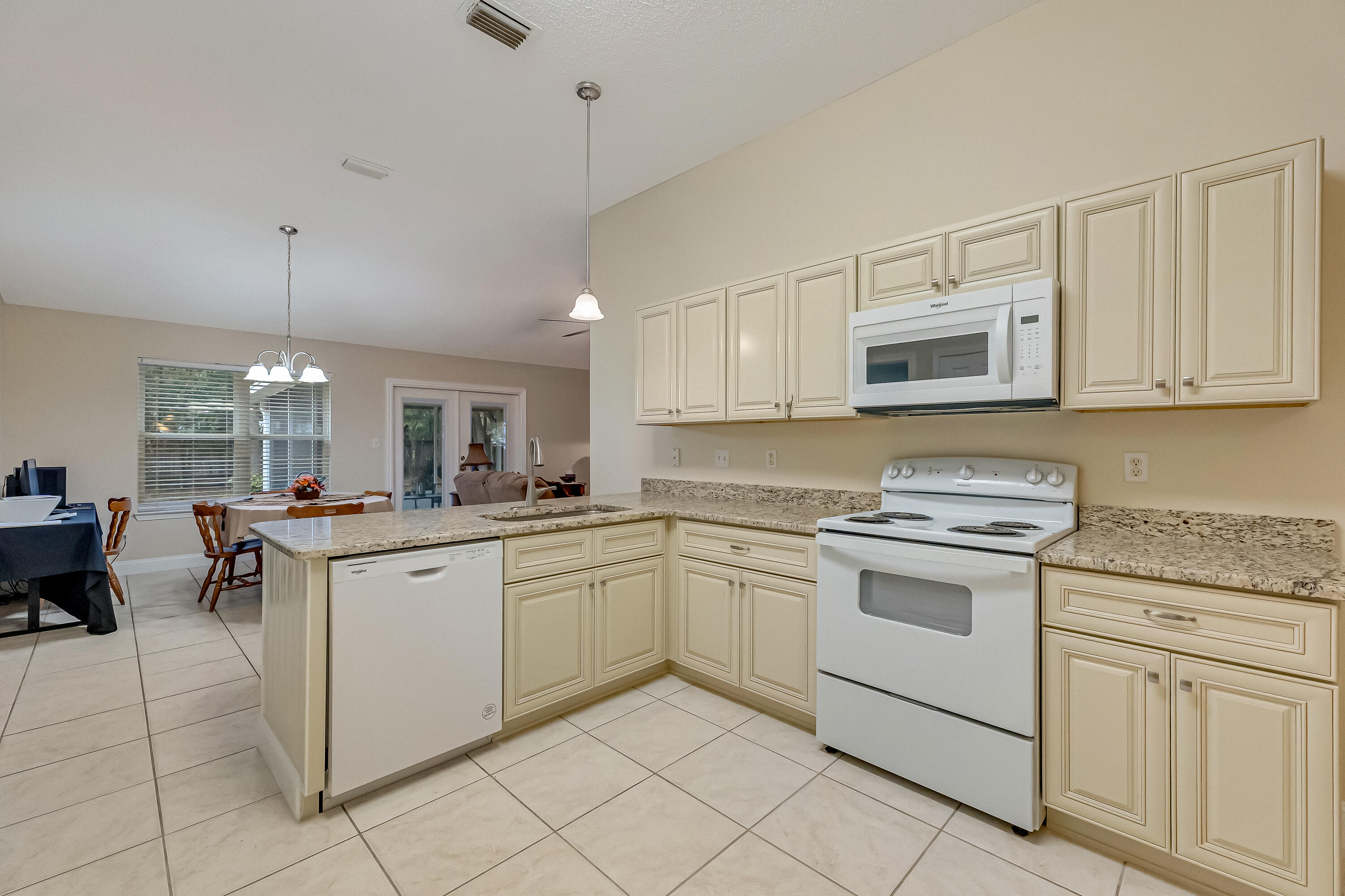 4730 Connor Drive Crestview, FL 32539 - Photo 19 of 71 a kitchen with cabinets appliances a sink and a counter top space
