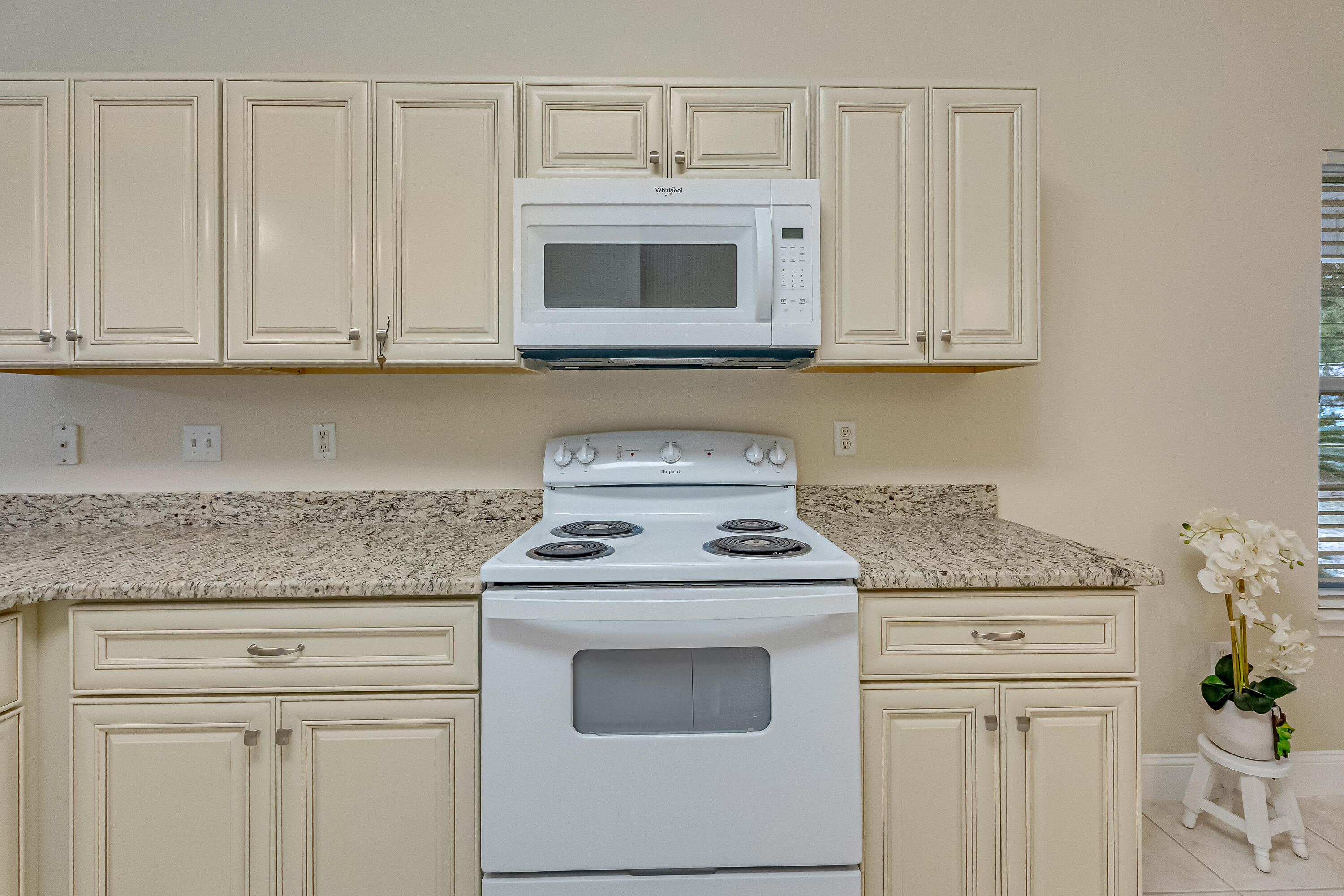4730 Connor Drive Crestview, FL 32539 - Photo 22 of 71 a kitchen with granite countertop white cabinets and white appliances
