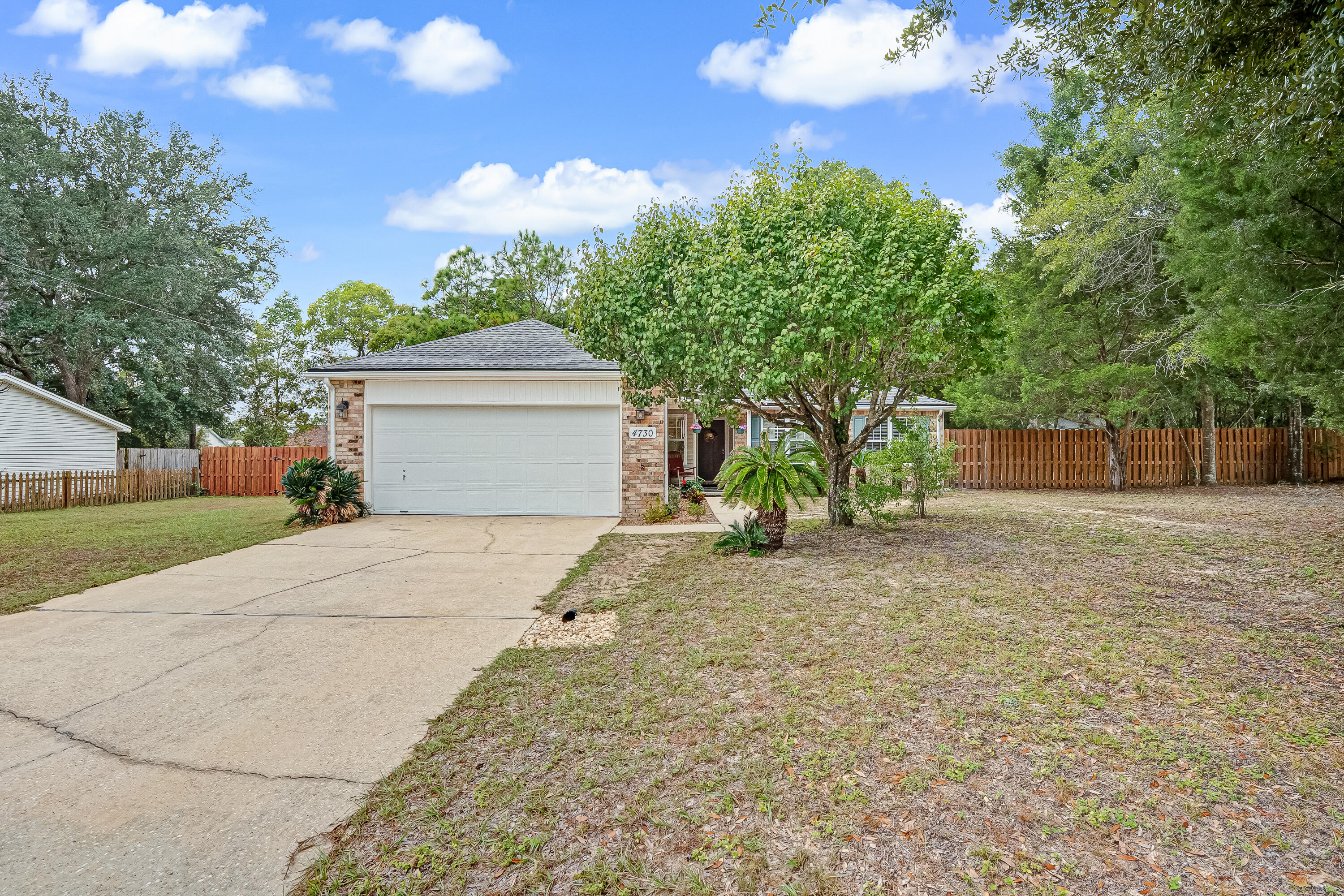 4730 Connor Drive Crestview, FL 32539 - Photo 3 of 71 a front view of a house with a yard and garage
