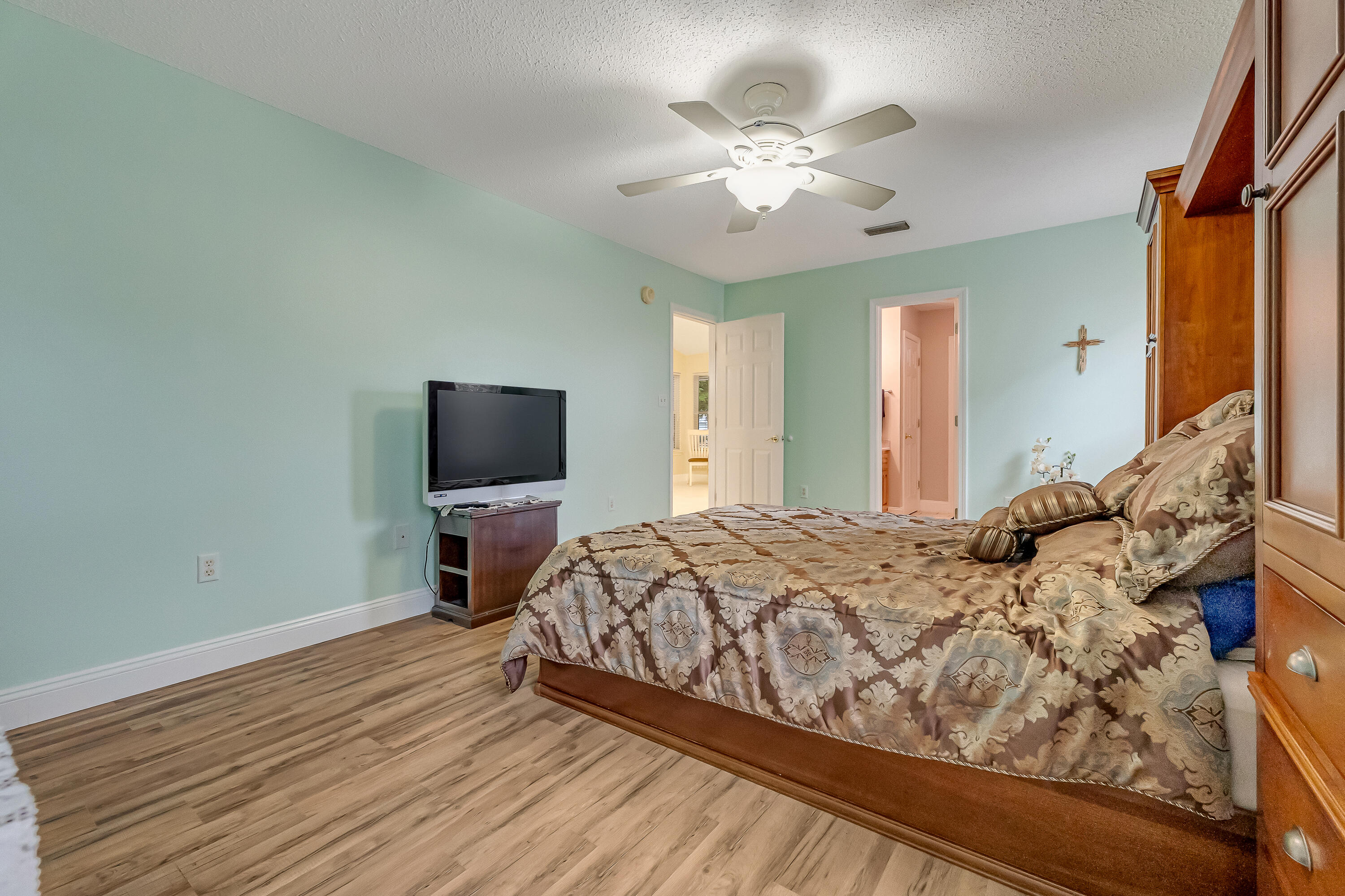 4730 Connor Drive Crestview, FL 32539 - Photo 31 of 71 a bedroom with a bed and a chandelier