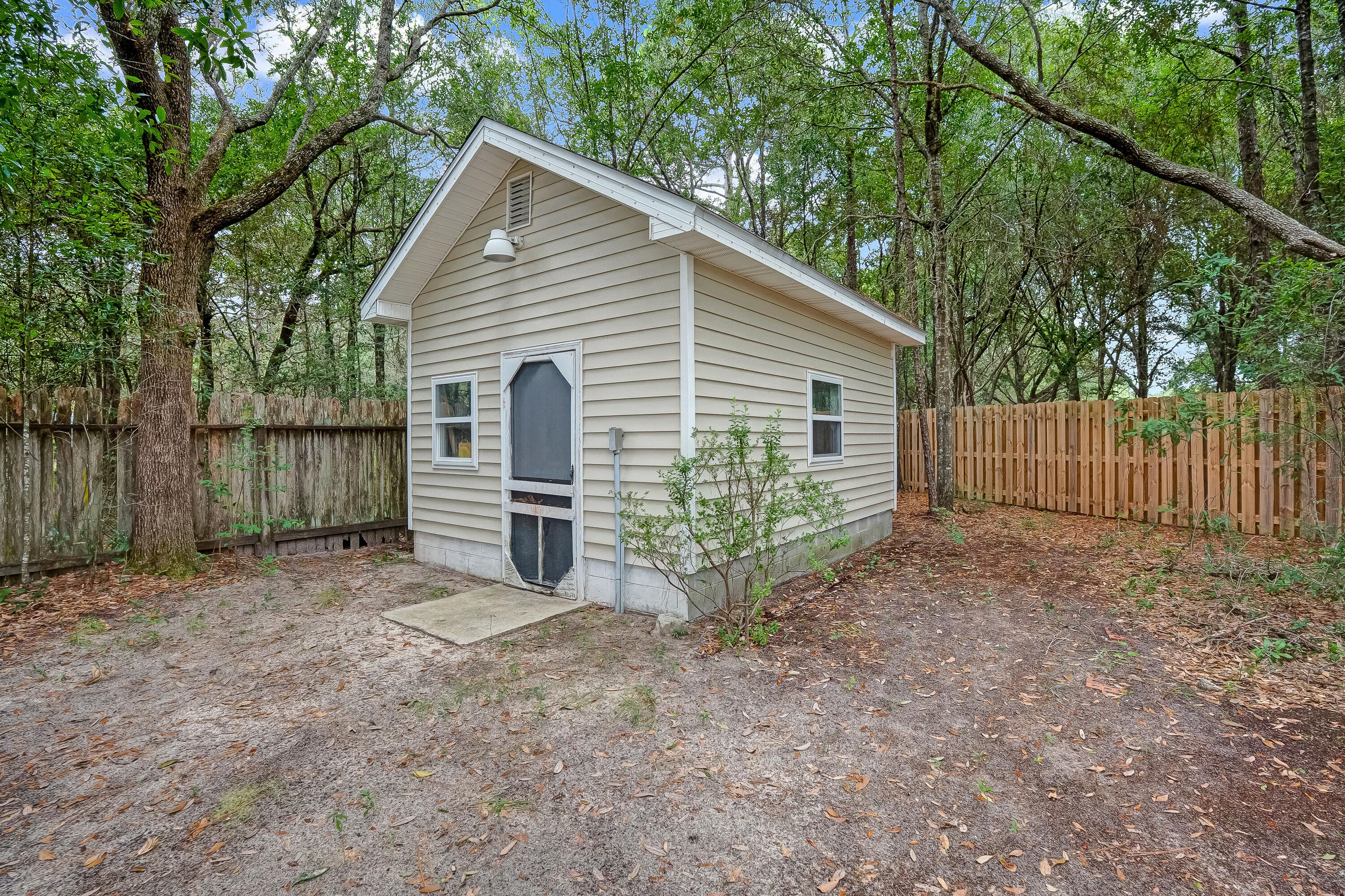 4730 Connor Drive Crestview, FL 32539 - Photo 58 of 71 a view of a house with a yard and plants