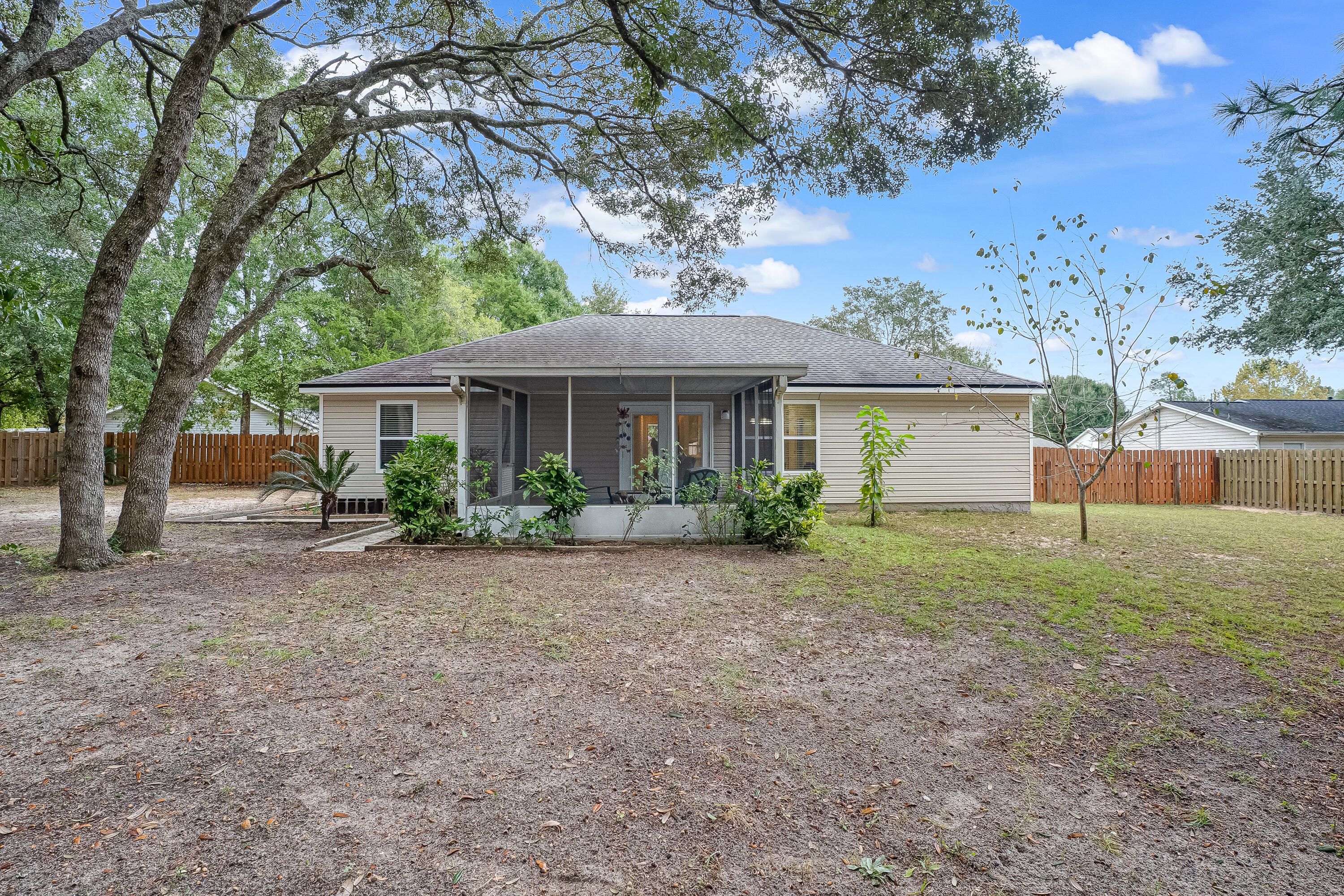 4730 Connor Drive Crestview, FL 32539 - Photo 60 of 71 a front view of a house with a yard and a garden