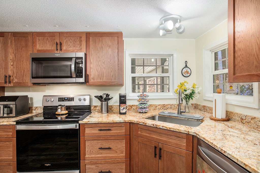 2226 Layson Road Hiawassee, GA 30546 - Photo 11 of 38 a kitchen with stainless steel appliances granite countertop a sink stove and microwave