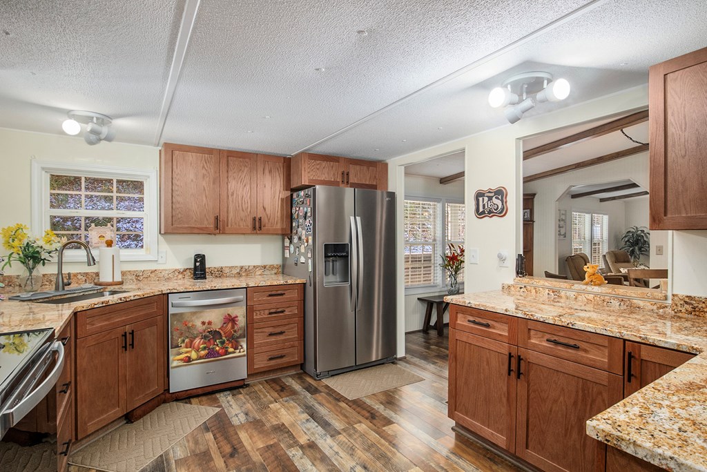 2226 Layson Road Hiawassee, GA 30546 - Photo 12 of 38 a kitchen with stainless steel appliances granite countertop a sink stove and refrigerator