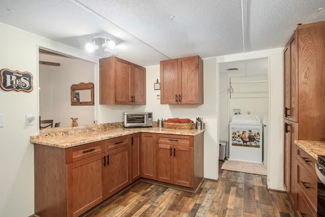a kitchen with a sink a stove and cabinets