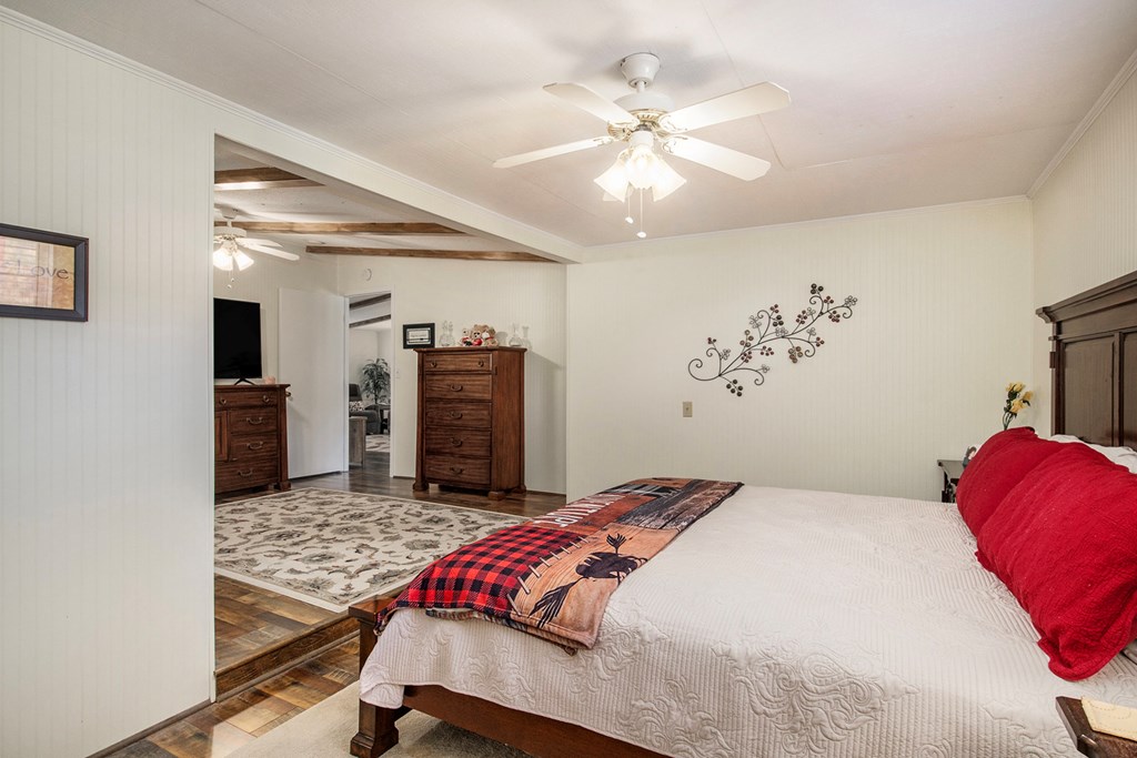 2226 Layson Road Hiawassee, GA 30546 - Photo 20 of 38 a bedroom with a bed and a chandelier