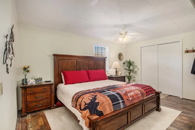 a bedroom with a large bed and a chandelier