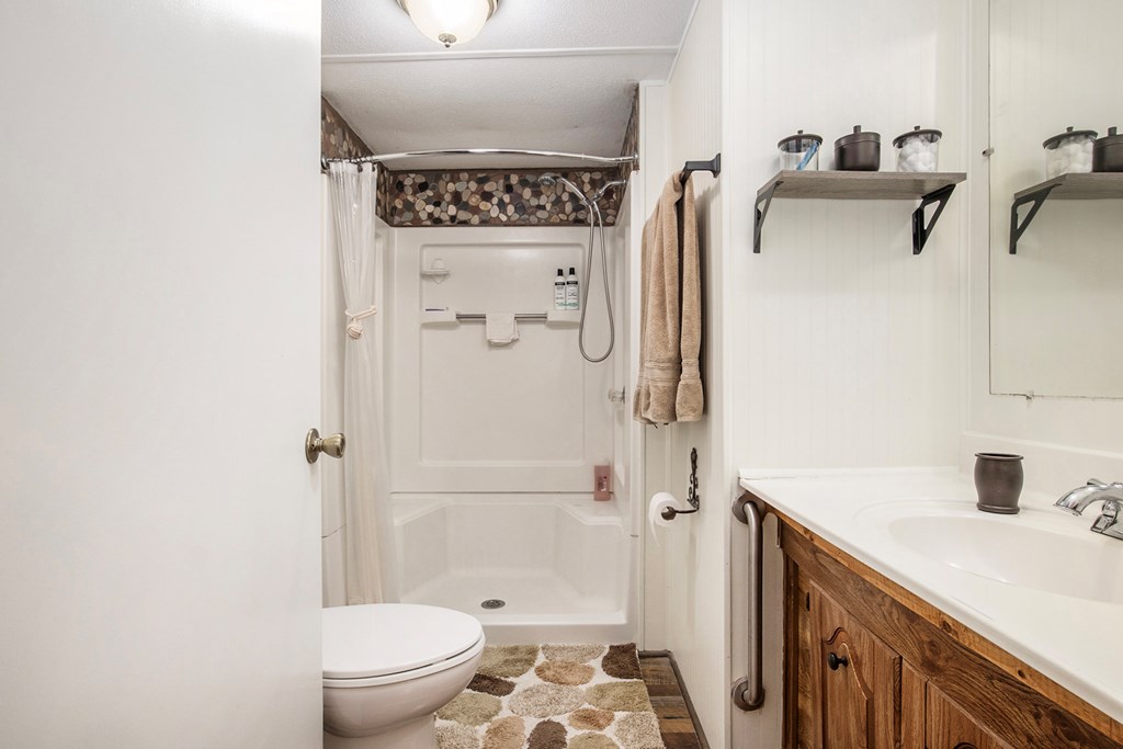 2226 Layson Road Hiawassee, GA 30546 - Photo 23 of 38 a bathroom with a sink a toilet and shower