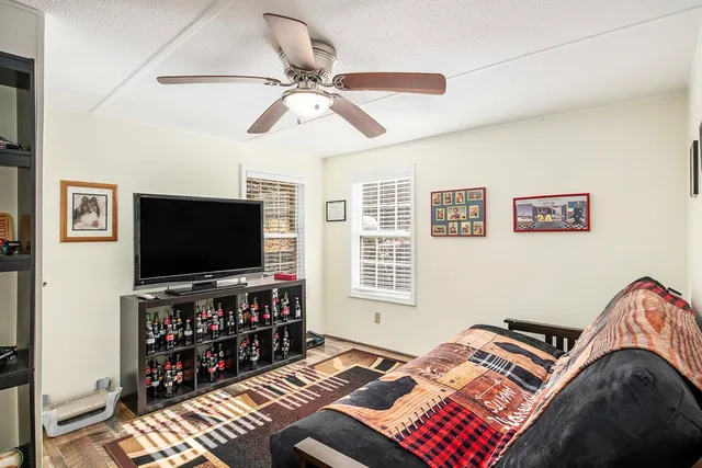 a bedroom with bed and a flat screen tv