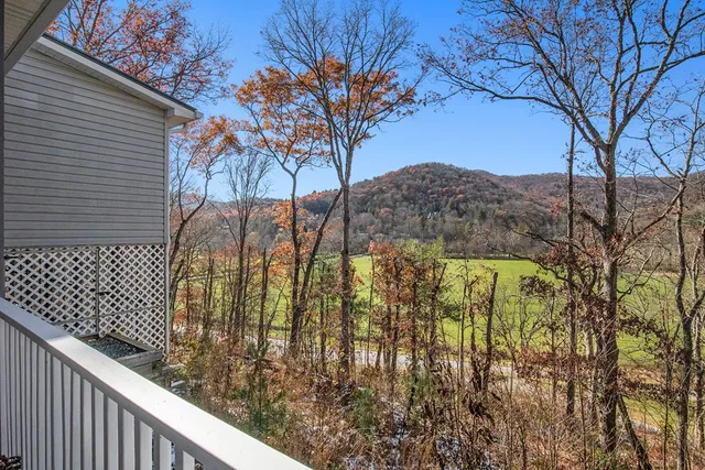 a view of house with backyard and seating area
